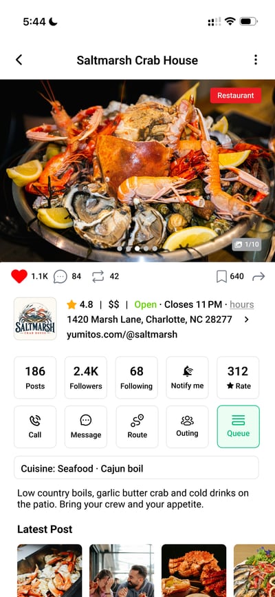 A business profile in the Yumitos app: a seafood platter photo, post and follower counts, and buttons to call, message, route, plan an outing and queue